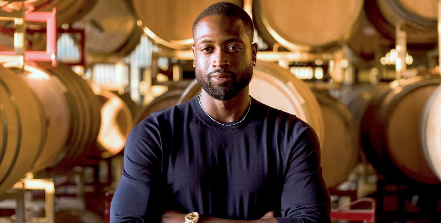 Dwyane Wade of Wade Cellars posing with wine barrels